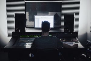 music producer sitting at a desk