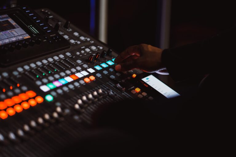 A music producer working on a mixer. Learn how to improve the quality of your mix